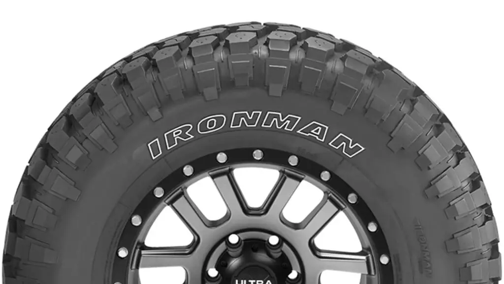 A close-up image of an Ironman all-terrain tire, showcasing its aggressive tread pattern.