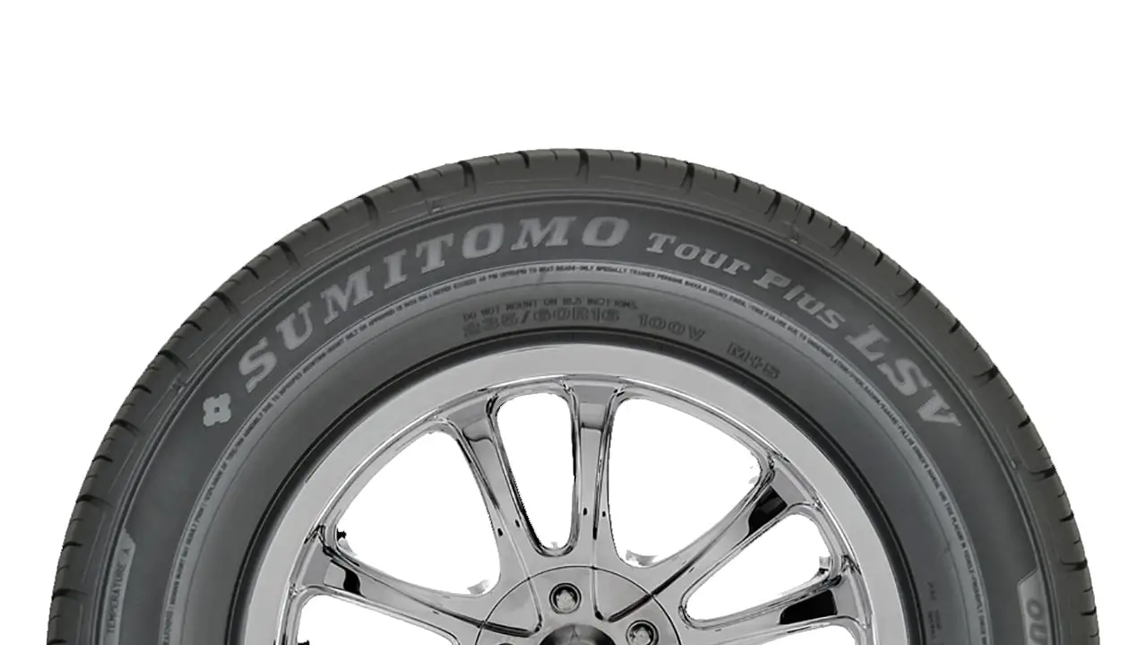 A close-up image of a Sumitomo Tour Plus LSV tire mounted on a chrome wheel.