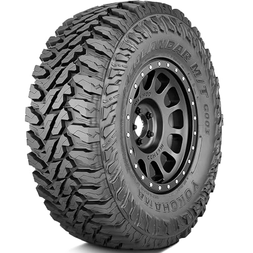 A heavy-duty off-road tire with an aggressive tread pattern designed for trucks like the 2500HD Duramax.